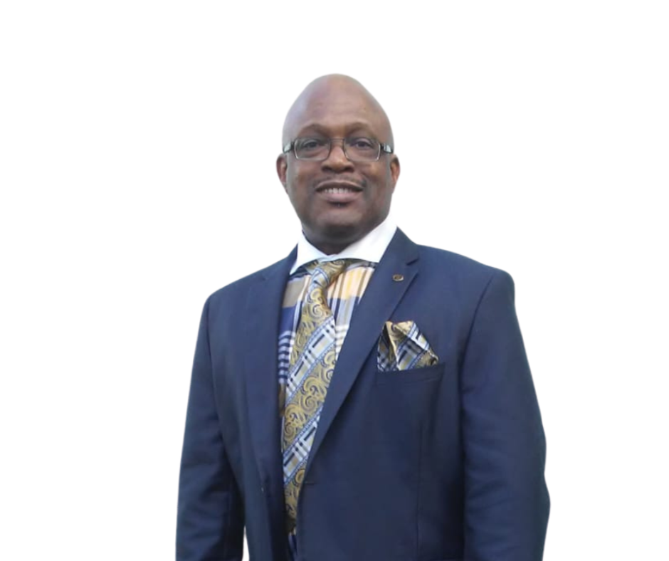 A man in a suit and tie standing up against a white wall.