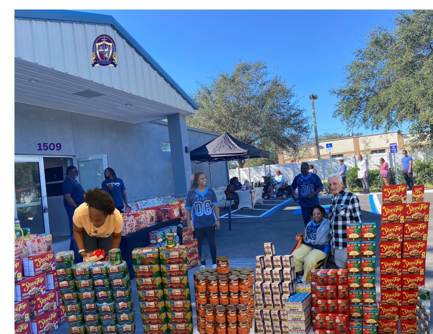 A group of people standing around cans on top of each other.